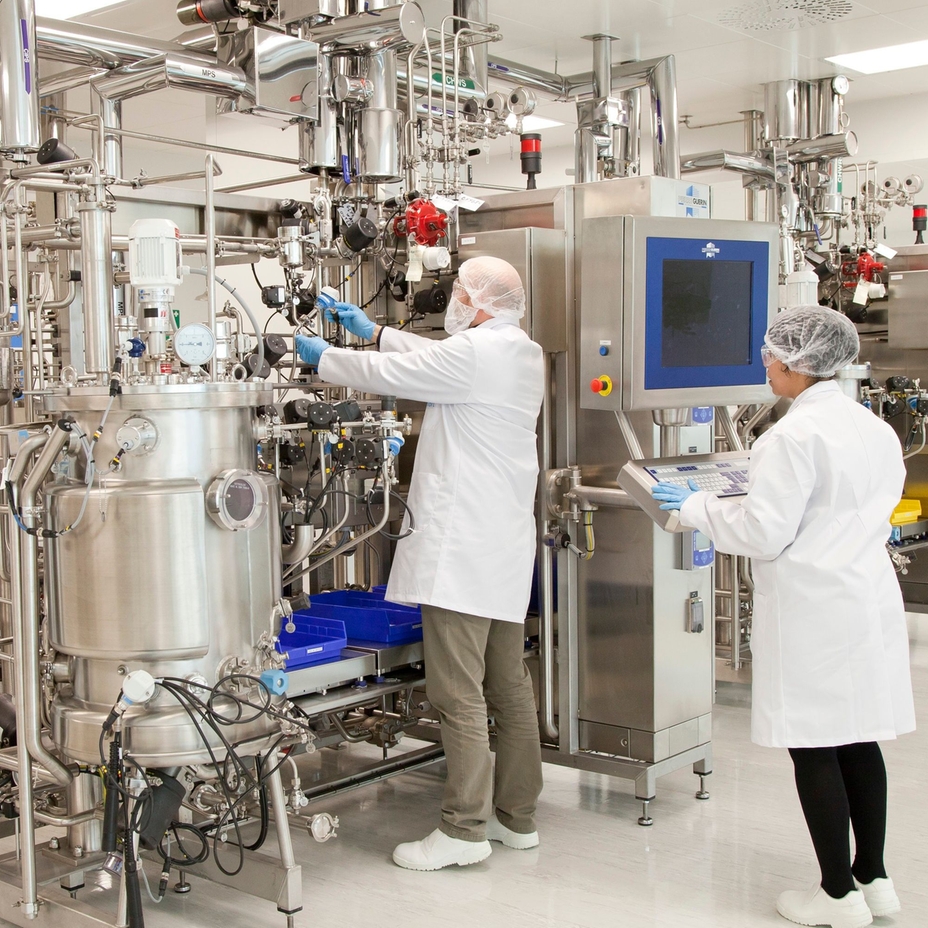 Scientists working with a bioreactor