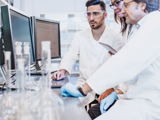 Scientists working in the laboratory looking at computer screen